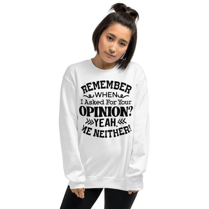 Woman wearing white cosy unisex sweatshirt with catchy opinion slogan.